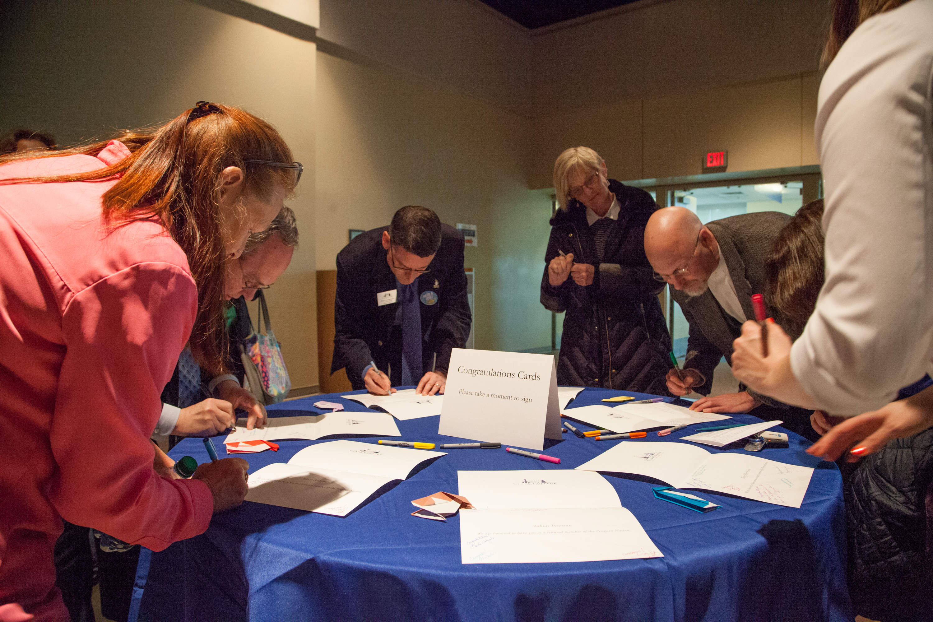 Signing congratulations cards for the newly tenured faculty