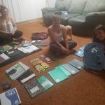 kids in house with backpacks and school supplies