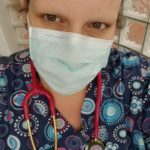 Candi Smith in scrubs and mask
